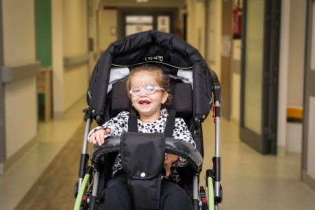 special needs child seated in black hippo buggy