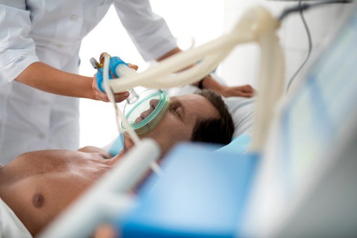 Patient on ventilator receiving in-hospital treatment by trained medical staff.